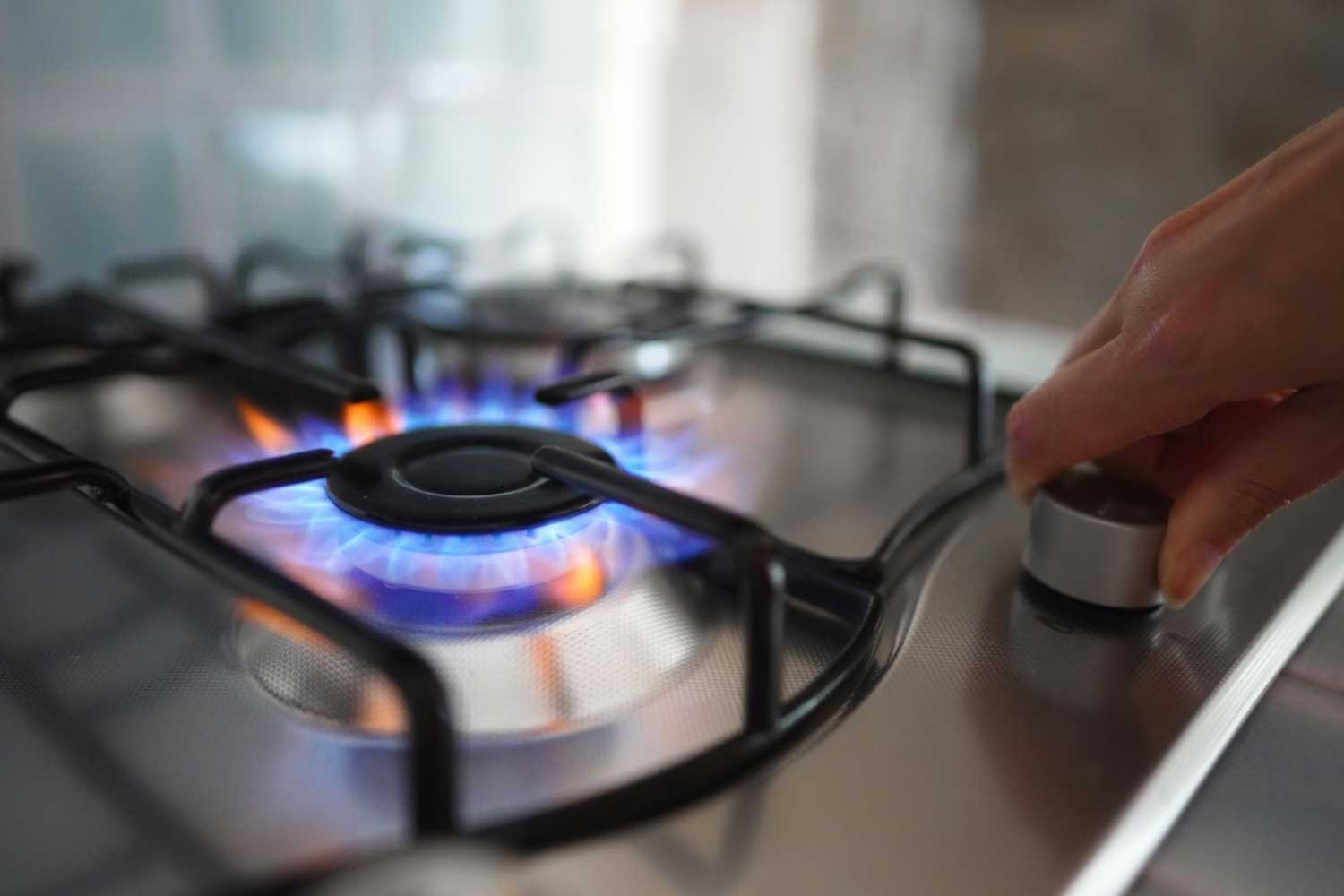 Gas A gas cooktop burner alight in a North Sydney kitchen.