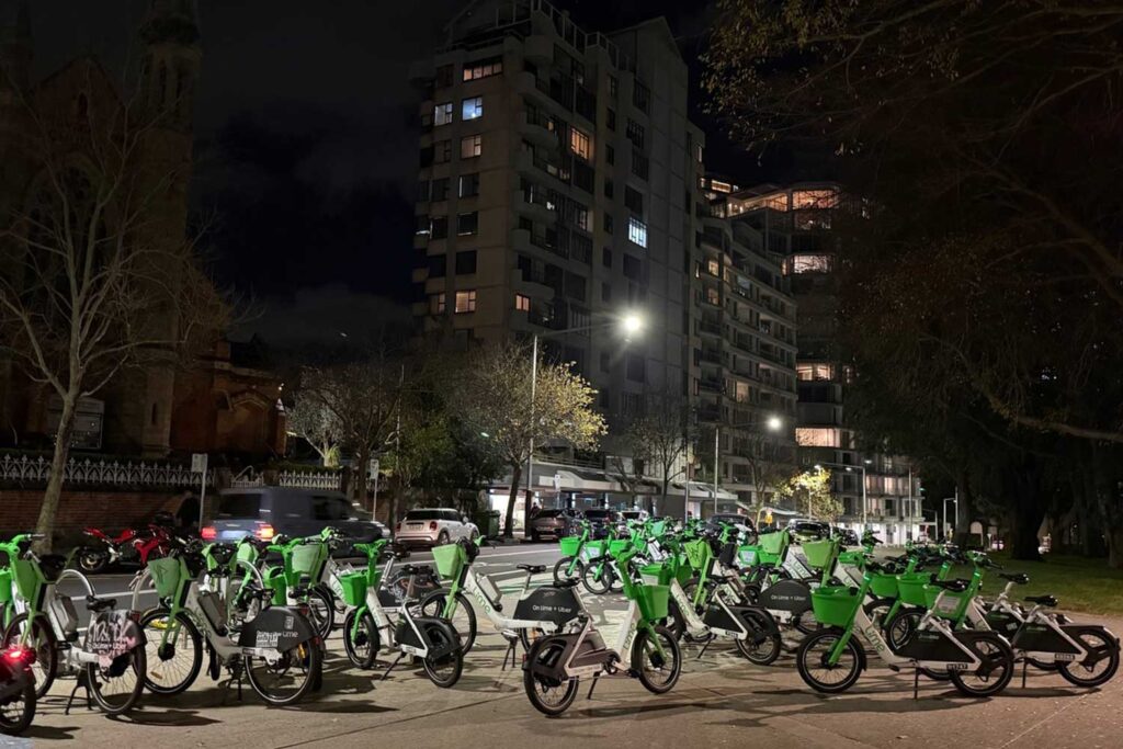 At least 100 Lime Bikes blocked the footpath outside Milsons Point Station on Sunday, with passersby needing to walk on the road to get around them.