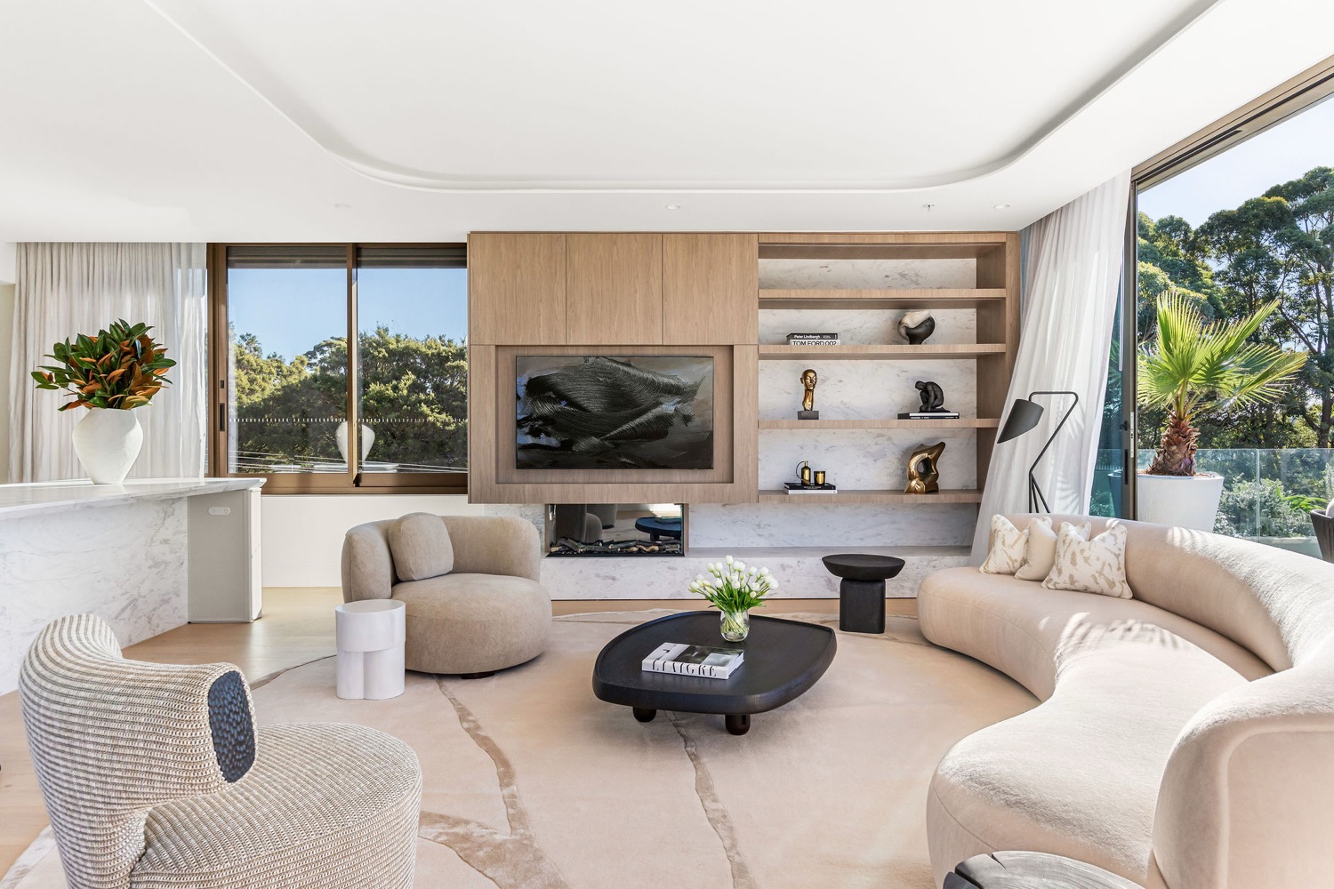 The Park Residences penthouse living room, with feature fireplace, timber joinery and bronze sculptures curated by Jack Freeman of FREEMAN and CO.