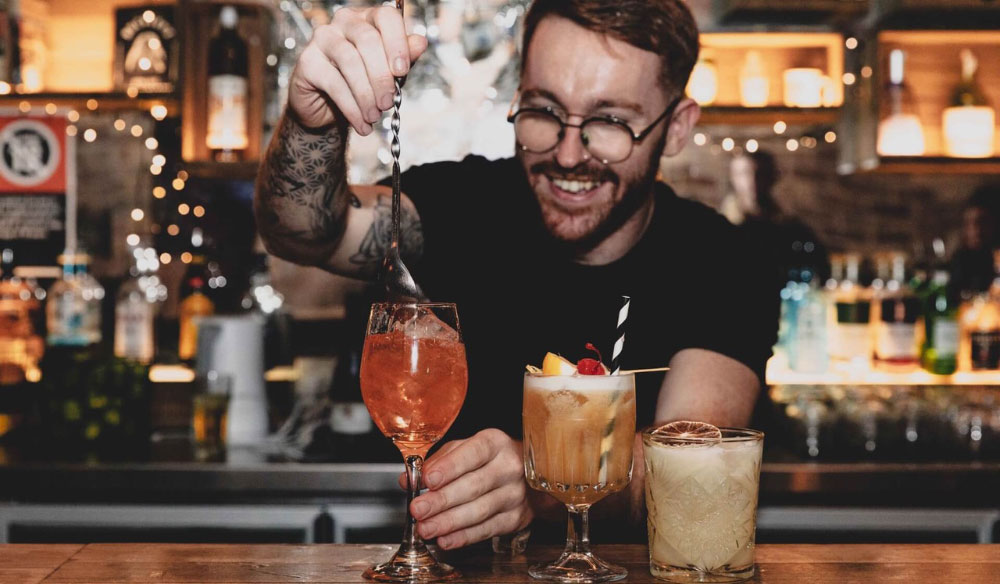 Barman mixing a cocktail at Stone the Crow