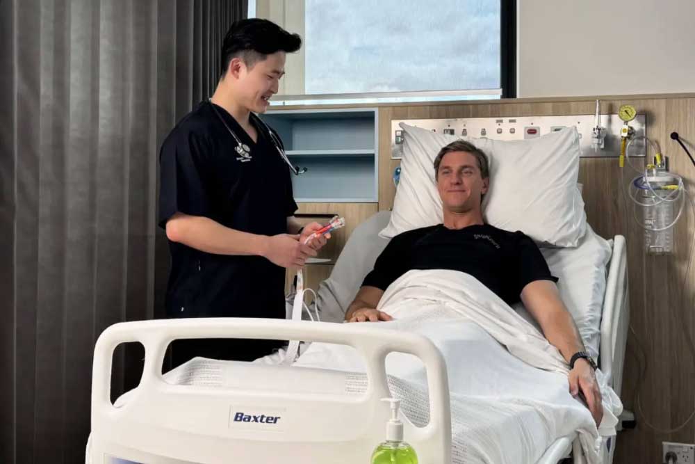 Male in bed having pusle taken
