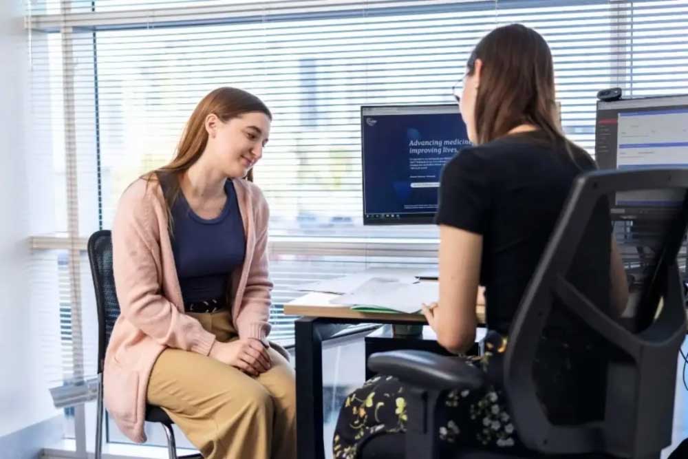 Female doctor talking to female patient