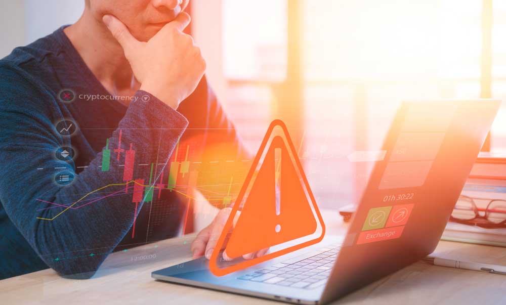 Pump-and-Dump-Scam-1 Male concerned look while working on this laptop