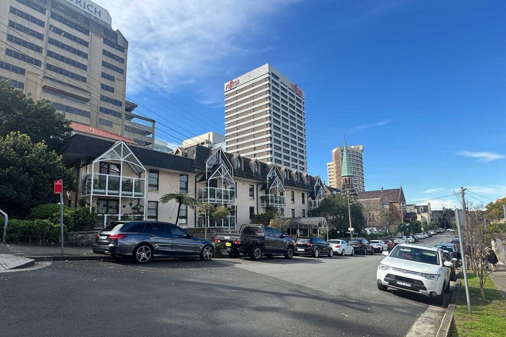 Xavier Terrace retirement village on Mackenzie Street, Lavender Bay, with the St Francis Xavier Church spire behind it.