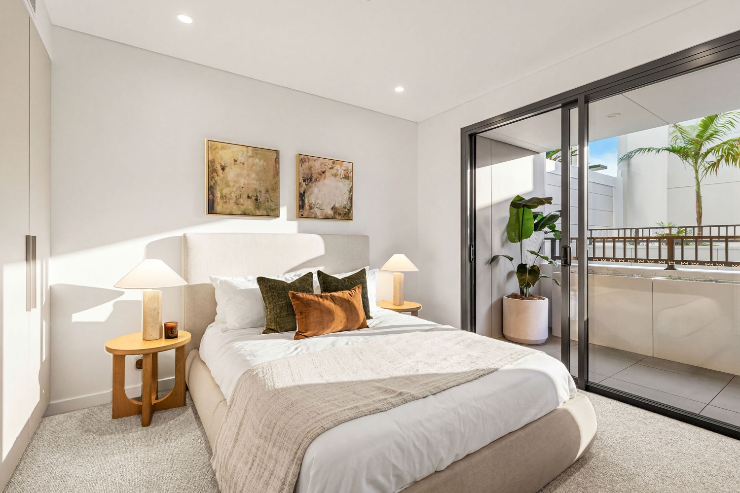 Bedroom in a Northcote Collective apartment, Naremburn, opening to a private terrace.