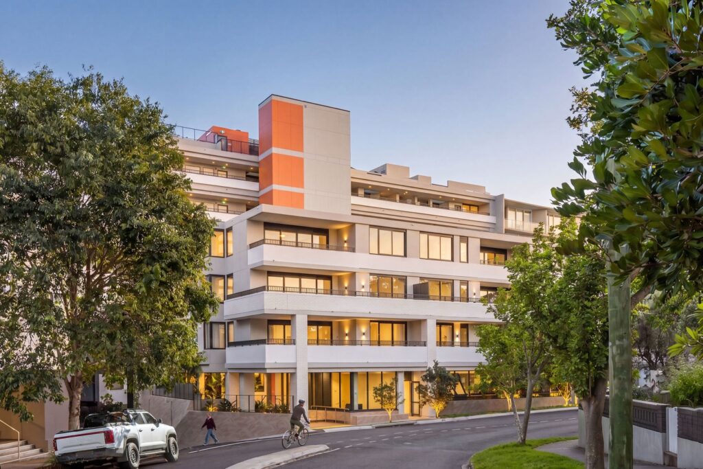 Northcote Collective apartment building on Northcote Street, Naremburn, at dusk.