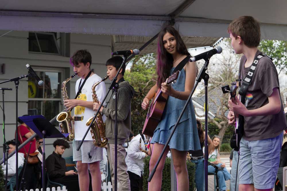 children on stage playing music