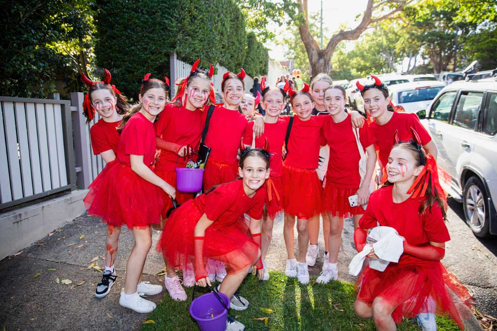 Ten girls dressed in red for Halloween Ten girls dressed in red for Halloween in the street