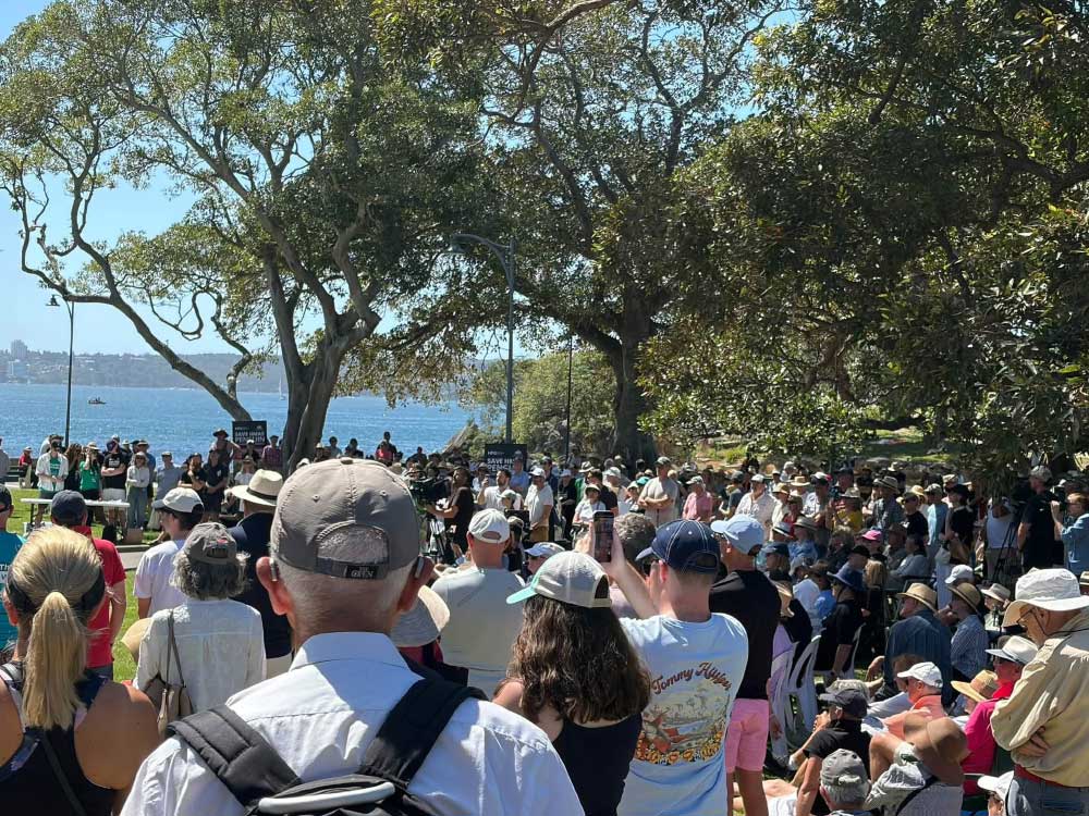 large crowd of supporters attending meeting at the site