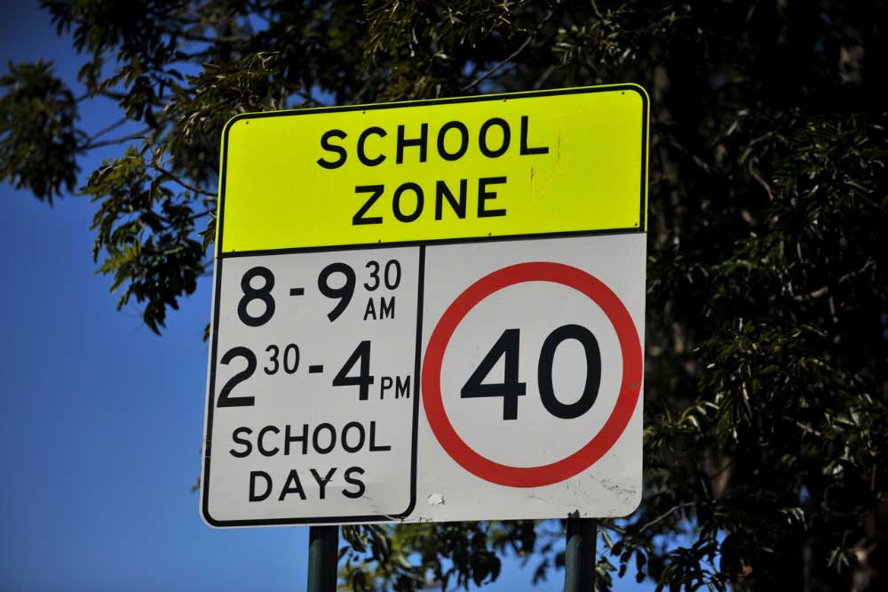 A 40km/h school zone sign showing the 8am to 9:30am and 2:30pm to 4pm school day hours.