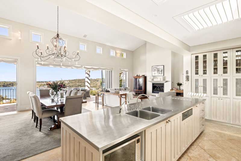 open plan stainless steel kitchen over looking ocean